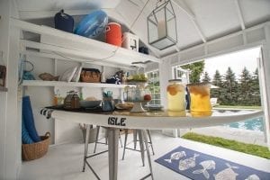 Pool shed interior. Table shaped like surf board with food on top.
