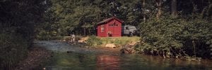 Red fishing shed on a lake.