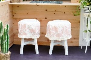 Shed detail: Two stools covered in light pink fabric.