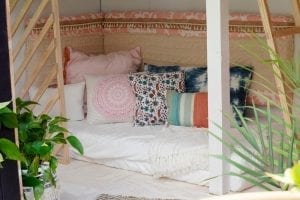 Shed detail: Bed with throw pillows.