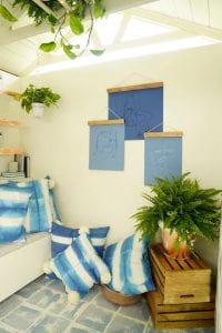 Shed detail: Blue throw pillows and hanging wall art.